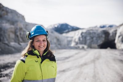 a woman wearing Volvo jacket, smiling in front of a Norwegian quarry