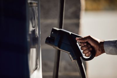 Old woman looking down at a phone and smiling