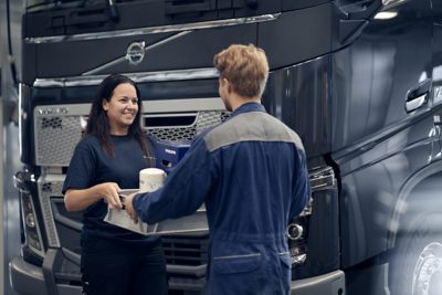 Service team talking in front of truck