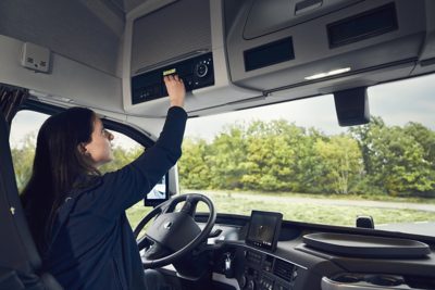 Driver walking beside truck with clipboard