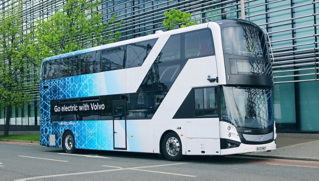 A Volvo BZL Electric double-decker driving down a street