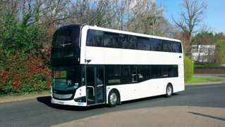 A Volvo BZL Electric double-decker driving down a street