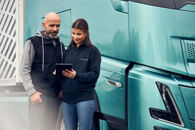 Dealer and Driver with iPad in front of FH Aero Electric truck