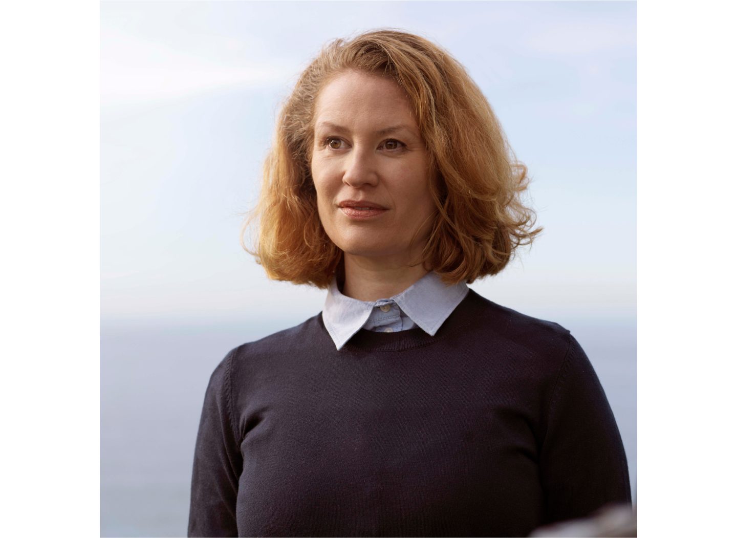 A female coach driver with red hair