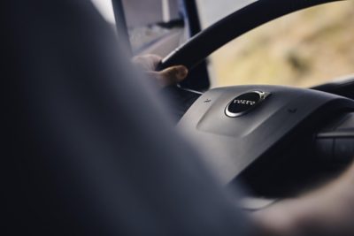 Closeup of two hands on a steering wheel