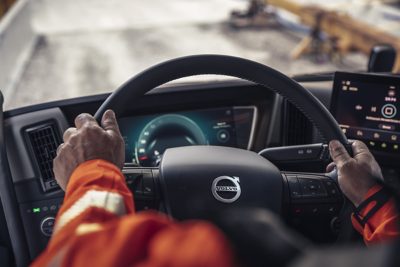 Closeup of two hands on a steering wheel