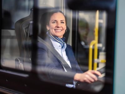Female bus driver behind the wheel of a A Volvo B8L DD – MCV Evoseti