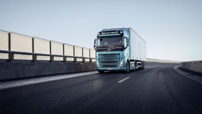 A front-angle view of a Volvo FH driving on a highway