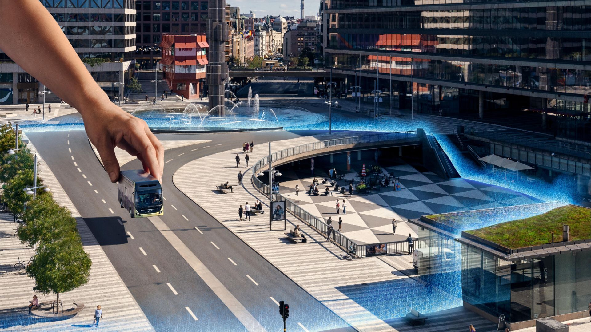 A giant hand places a Volvo bus onto a city street.