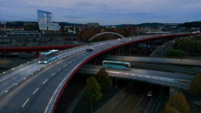 Volvo bus crossing highway at night