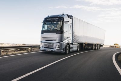 A truck drives down a curving slope