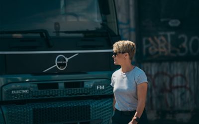 Person walking in front of a Volvo FM Electric