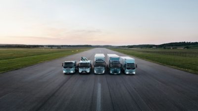 The complete range of Volvo electric trucks lined up on a runway