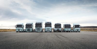 The complete range of Volvo electric trucks lined up on a runway