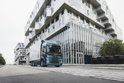 An electric truck drives through the city