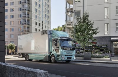 An electric truck drives through the city