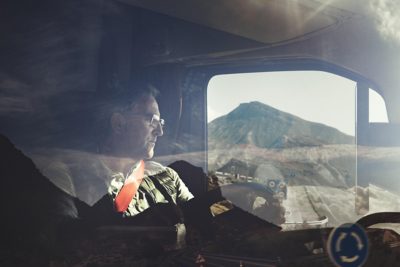 Man driving a truck, looking out the window