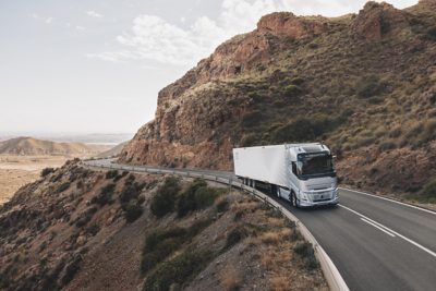 Model Volvo FH Aero jazdí po ceste, pohľad z boku a spredu