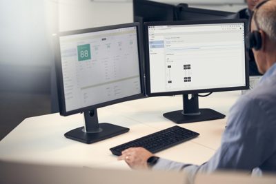 Man working at office, watching two screens