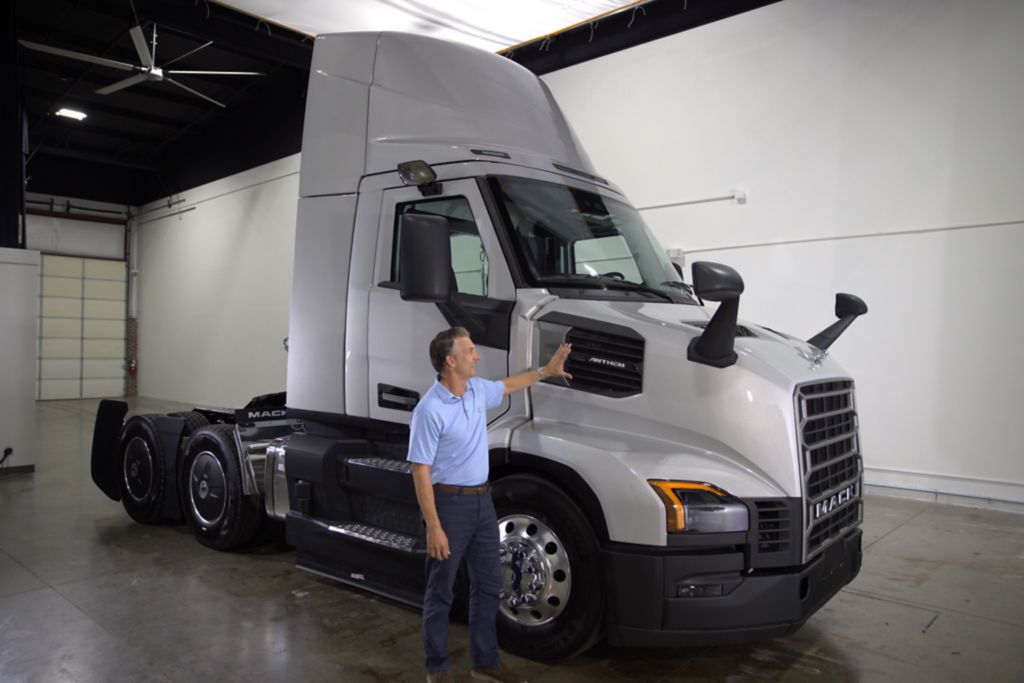 Man standing in front of gray Mack Truck