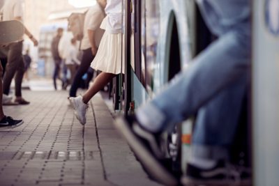 A crowd of people boarding a bus