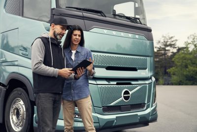 Customers and sales rep beside trucks