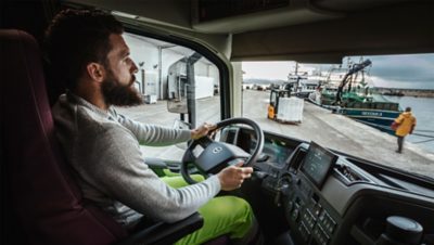 A driver drives his truck at a port