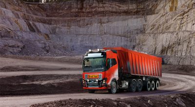  Self-driving truck loaded with crushed stones running down a road in a quarry