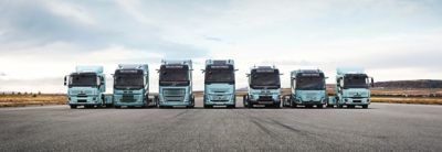 The complete range of Volvo electric trucks lined up on a runway