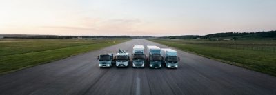 The complete range of Volvo electric trucks lined up on a runway