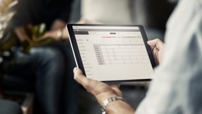 A tablet showing a Volvo Connect dashboard interface