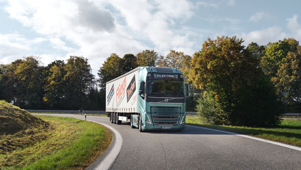 Volvo truck driving in the sunshine surrounded by green trees | Volvo Group