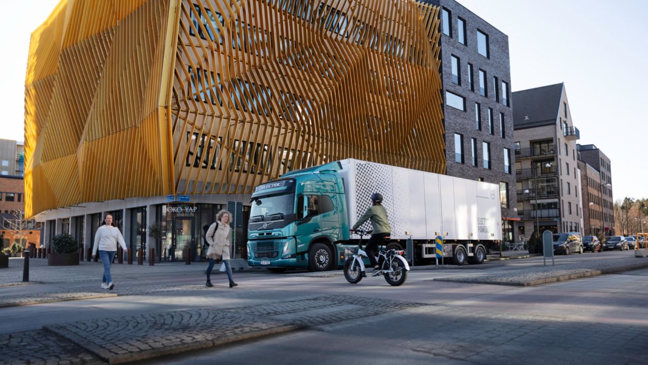 Volvo Truck parked outside of an orange building | Volvo Group