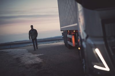 A man at sunset with a truck in the foreground