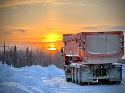 Volvo Truck in the snow facing a sunset