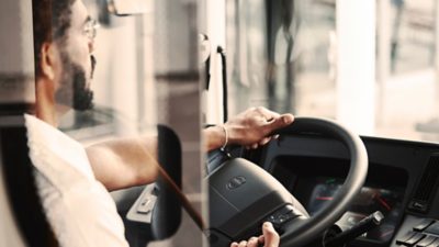 Bus driver plugging the charger into an electric Volvo coach