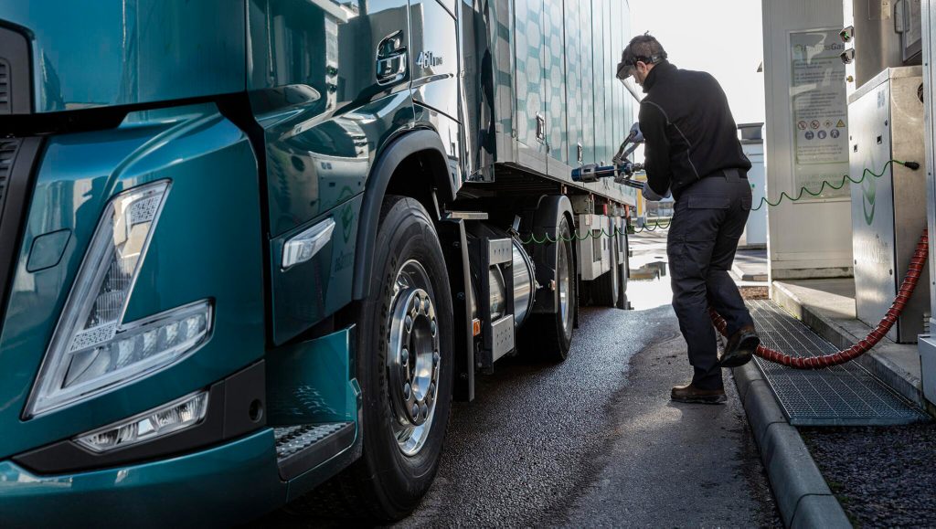 Man in front of gas-powered truck LNG