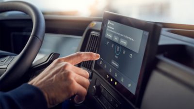 Driver pointing at screen inside truck