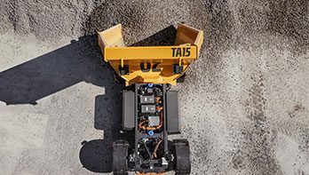 Volvo TA15 electric dumper unloads crushed stone in a stone pile