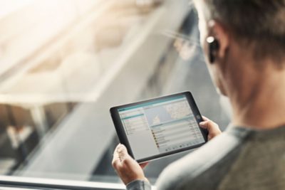 A person looking at vehicle data on a tablet