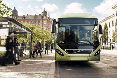 A full hybrid bus at a city bus stop