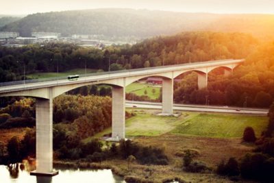 A full hybris bus drives across a bridge