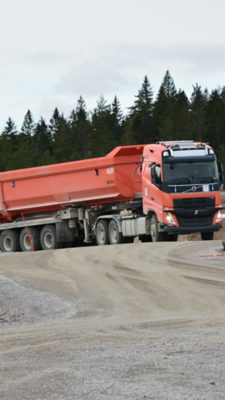 A truck driving autonomously in a quarry, and it's in the process of turning right from the viewer's perspective