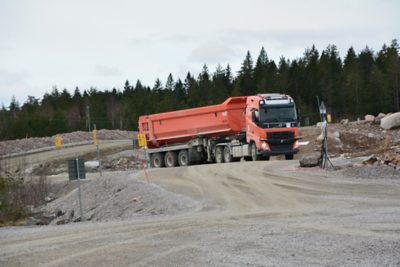 A truck driving autonomously in a quarry, and it's in the process of turning right from the viewer's perspective