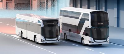 Two Volvo BZL Electric, one double-decker with a charging cable connected, and one single-decker, charging under an OppCharge pantograph.