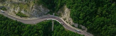 Birds Eye View - winding road from the high mountain pass in Sochi, Russia. Great road trip trough the dense woods.