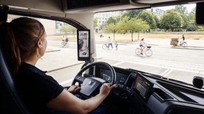 Children waving at truck driver