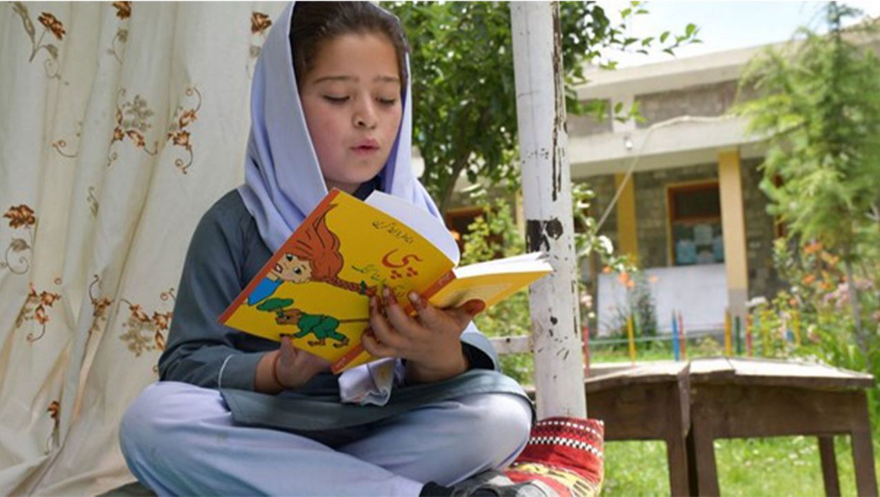 Girl in Pakistan reading Pippi Longstocking