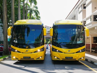 Two Volvo B7R buses alongside each other on the road