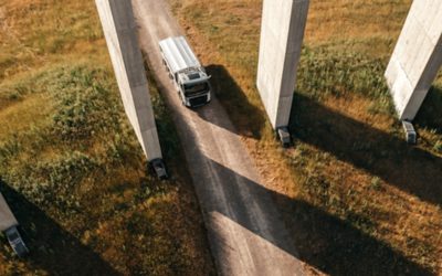 Truck driving on gravel road, viewed from above